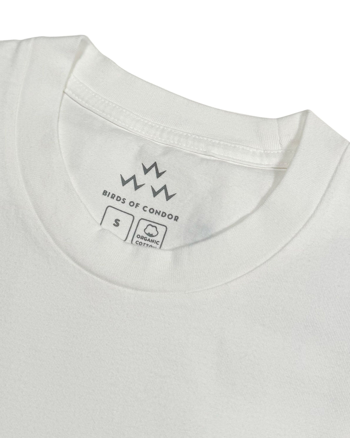 Detail of the white crew neck t-shirt showing the inner collar print and size label.