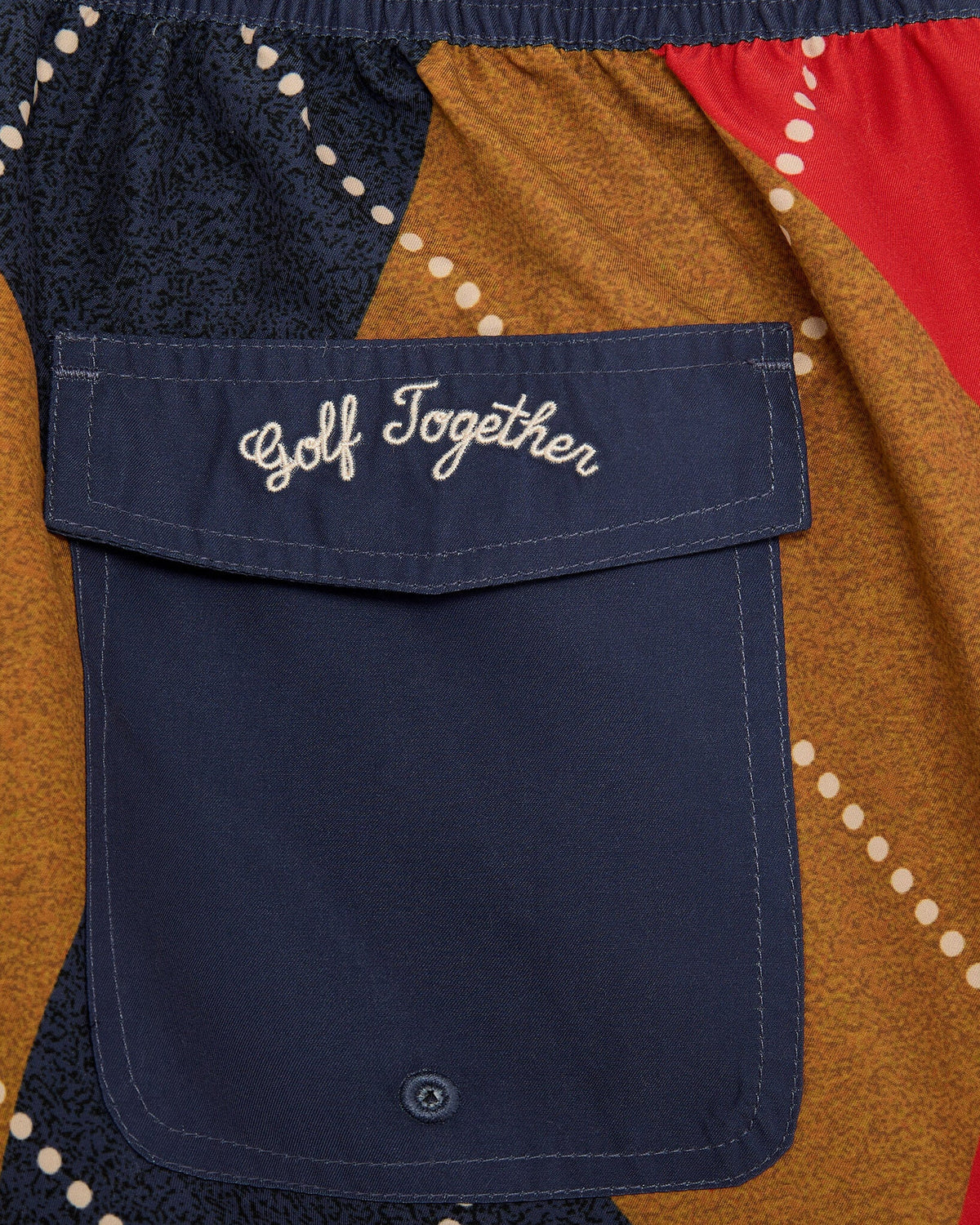 Detail of argyle walk shorts featuring a navy back pocket with white embroidered Golf Together text.