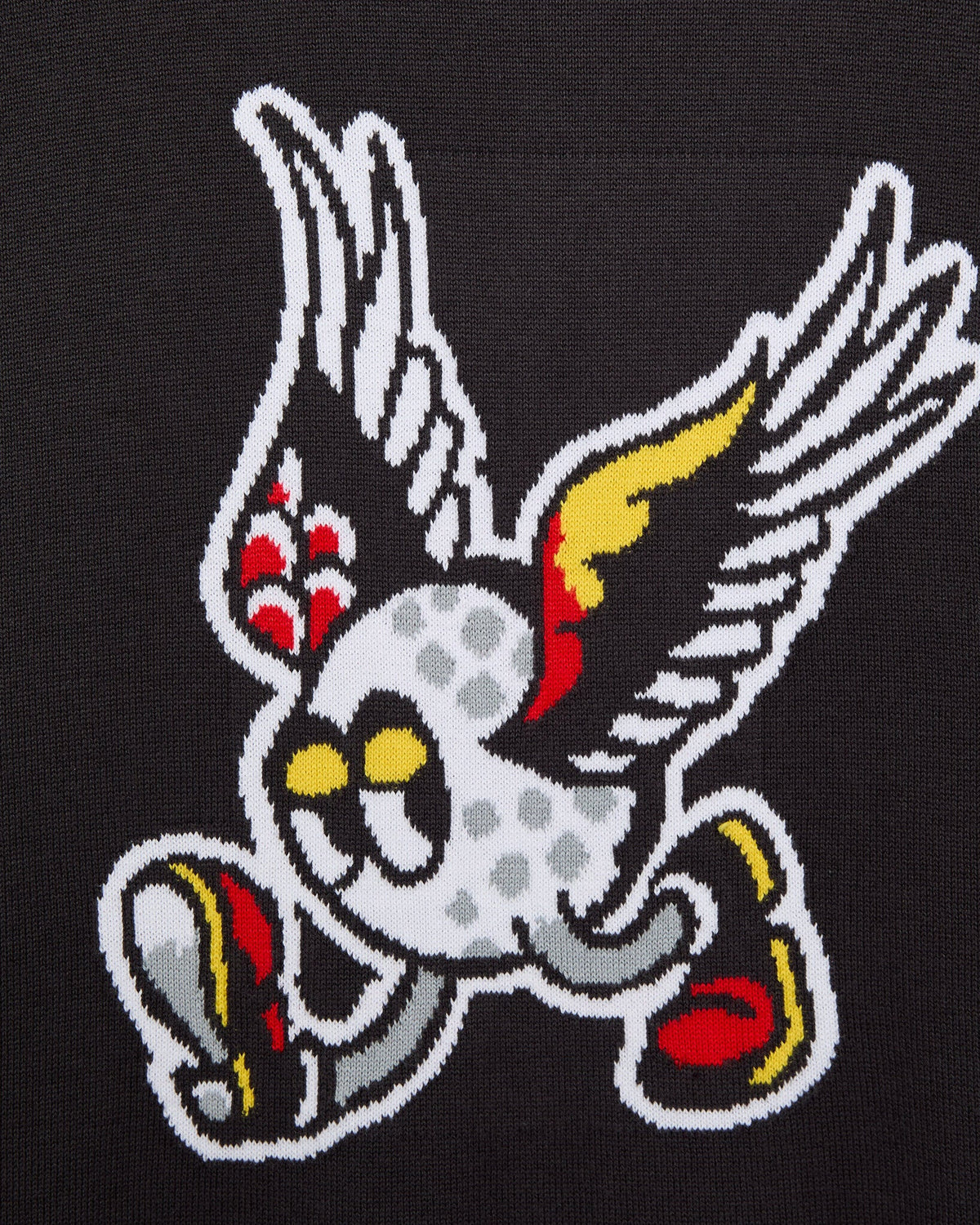 Detail of a phantom black knitted sweater with a cartoon winged golf ball graphic in white, red, and yellow.