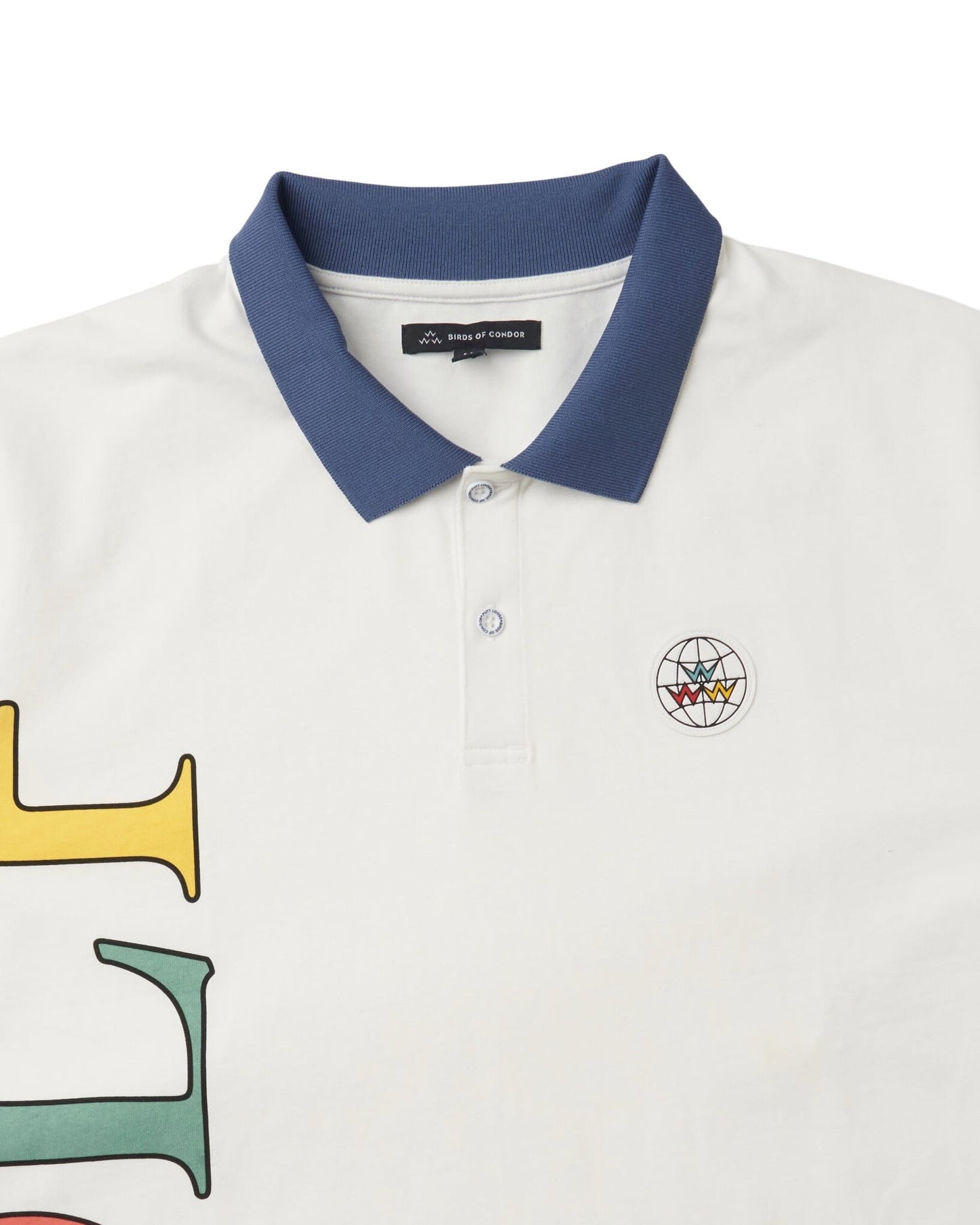 Detail of an off-white polo shirt featuring a blue collar, a two-button placket, and a globe patch.