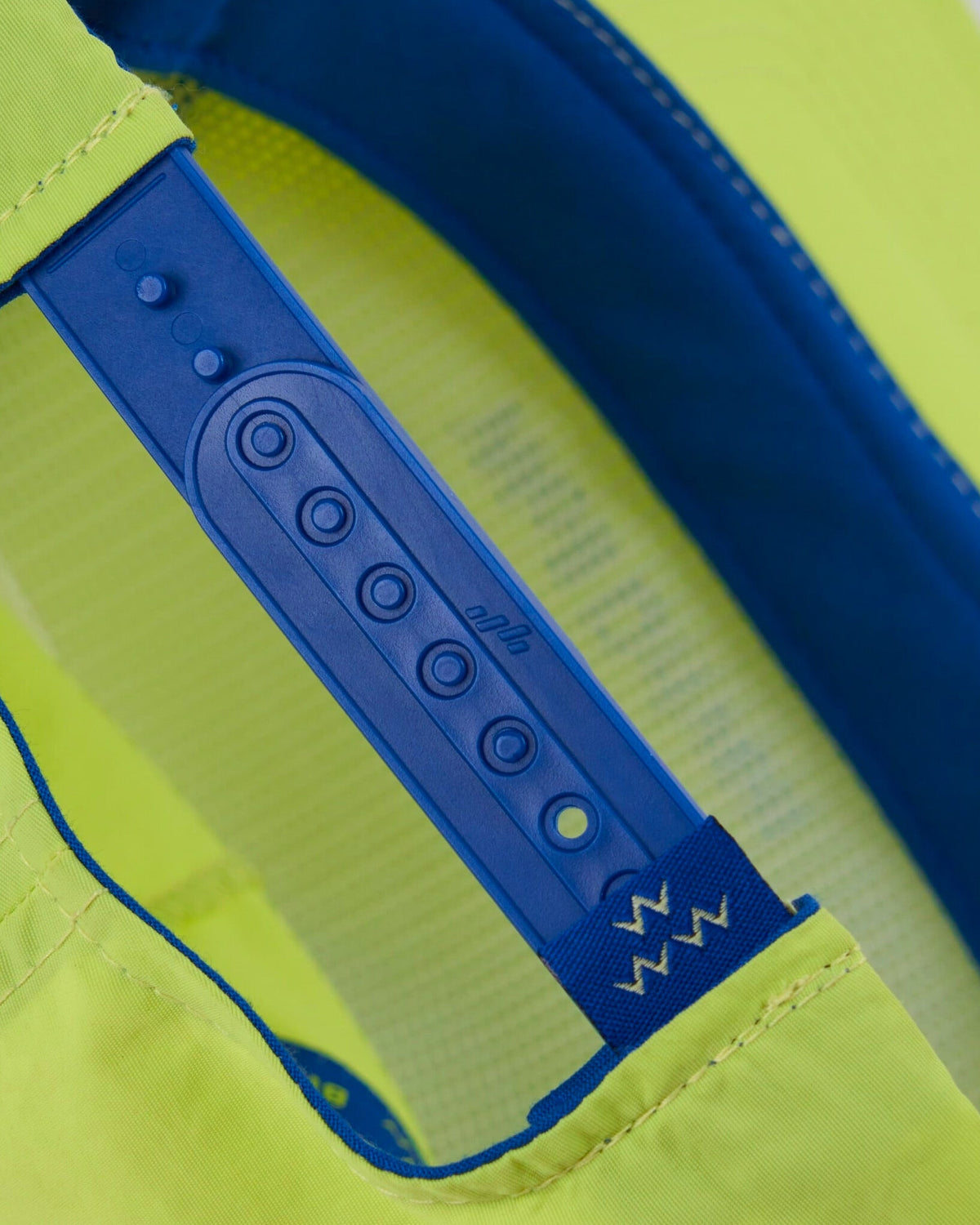 Back of a lime snapback cap with a blue plastic adjustable closure strap.