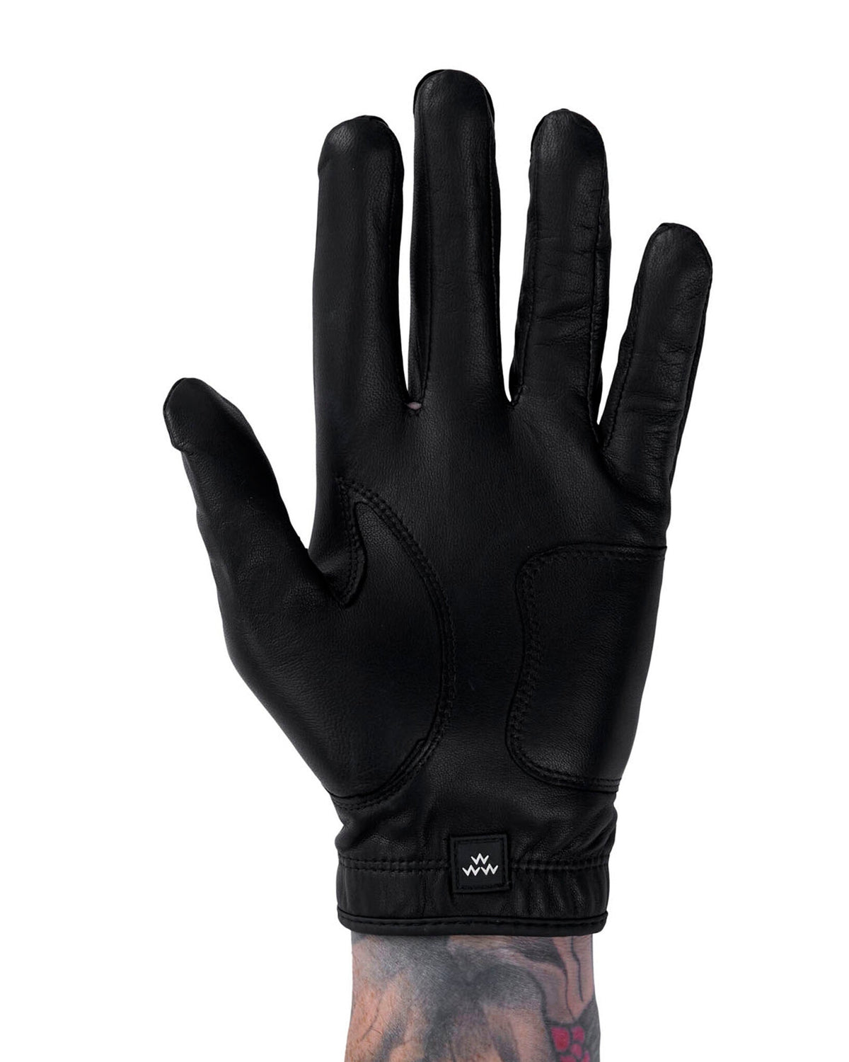 A black leather golf glove featuring reinforced palm panels and a small square wrist logo.