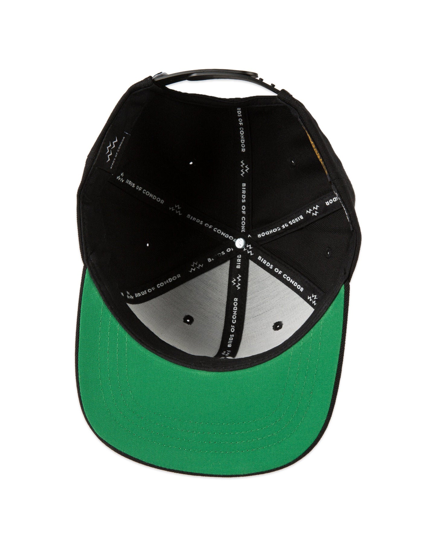 Inside of a black snapback cap with branded white seam tape and a solid green flat brim underneath.