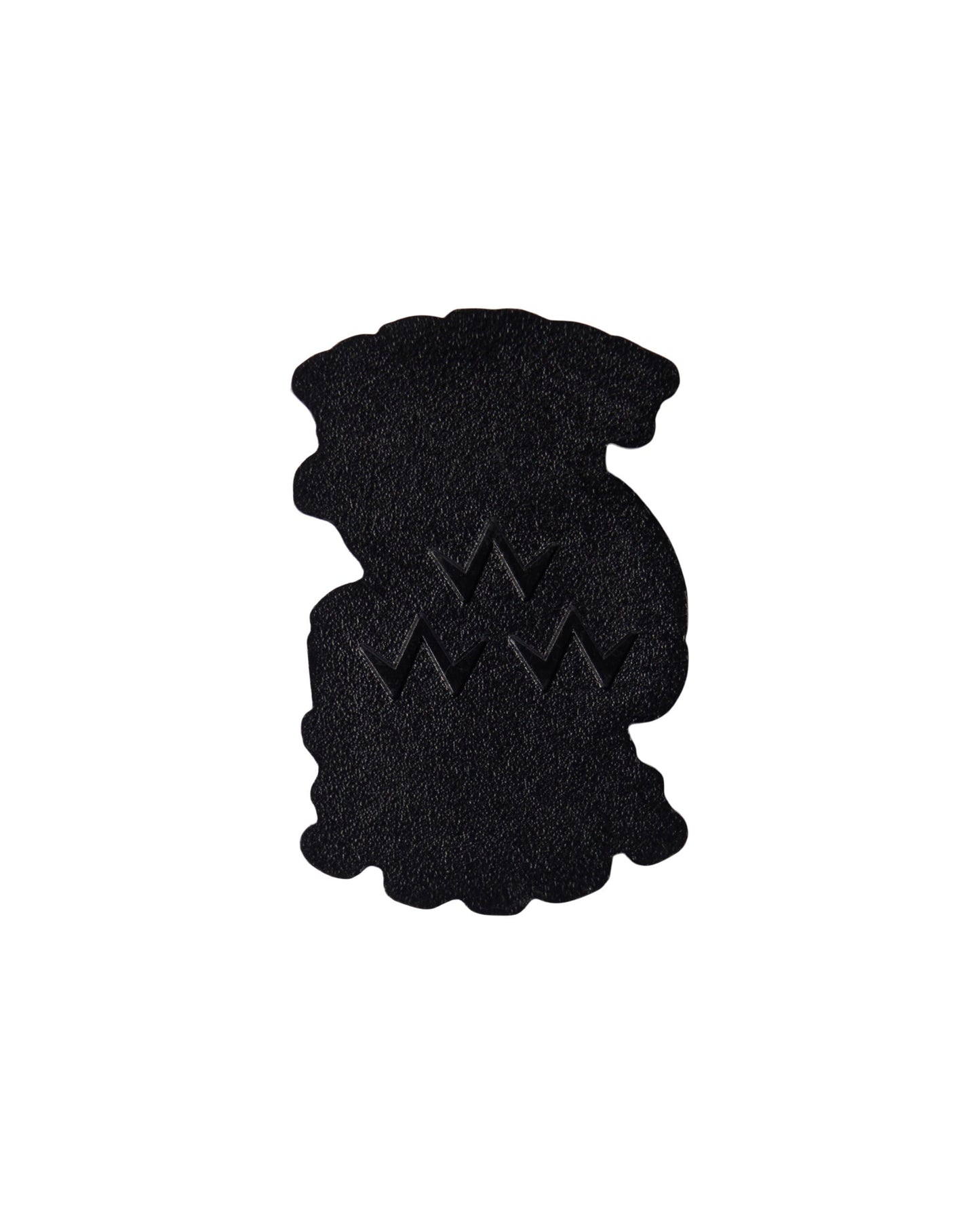 Back of a white golf ball marker featuring a pebble-textured metal surface with an embossed triple eagle logo.