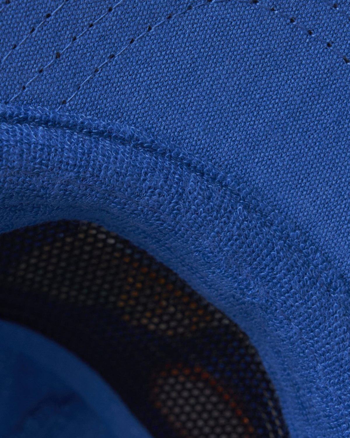 Detail of the blue 5-panel snapback featuring a soft terry inner headband.