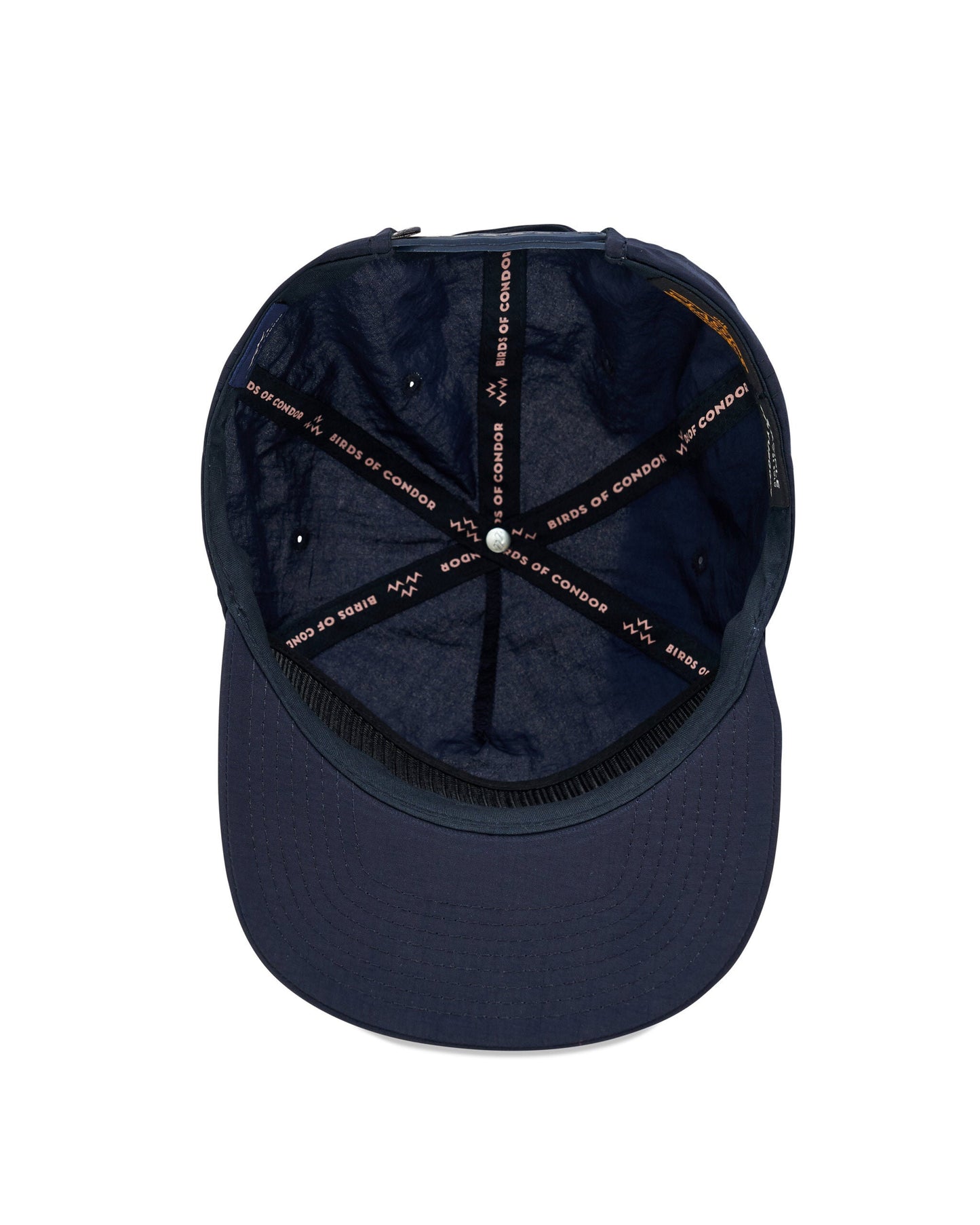 Inside of a navy cap showcasing branded interior taping and adjustable strap closure at the back.