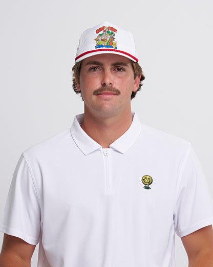 A man wearing a white snapback headwear featuring a cartoon logo above a red brim trim.