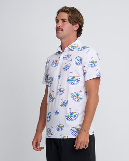 Man wearing a white polo shirt with half golfballs with vinyl record design and a red flag