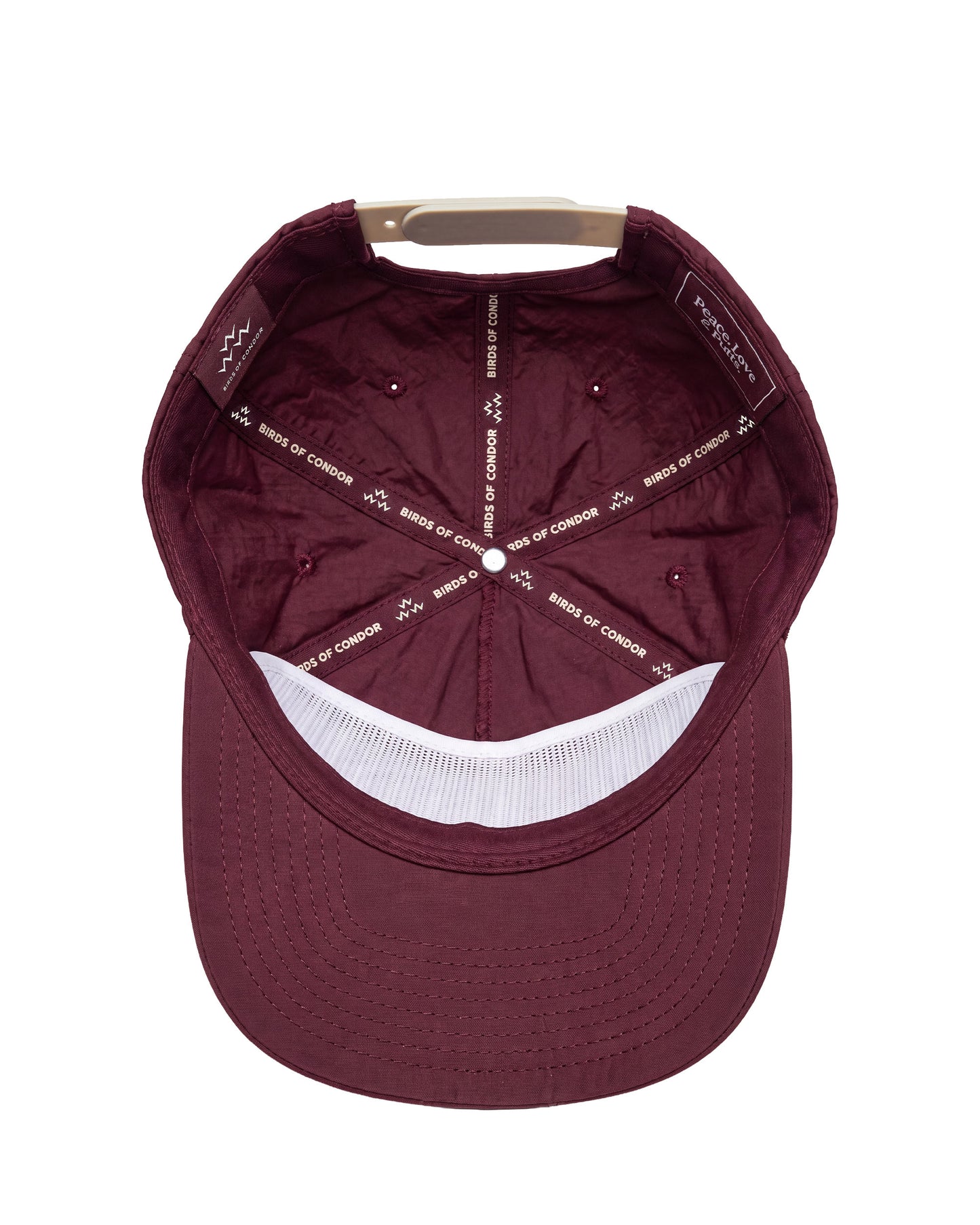 A top-down view of a maroon baseball cap with a white mesh band on the brim and white printed text on the interior panels.