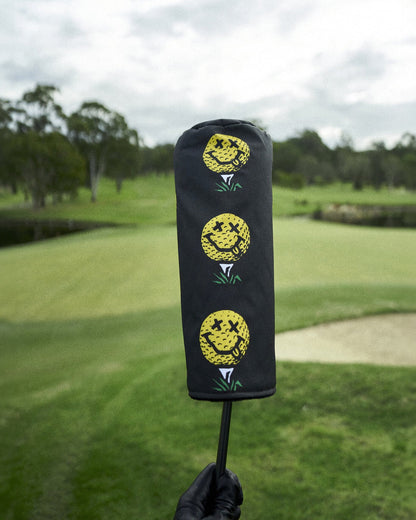 Black golf headcover featuring a vertical stack of three yellow smiley face golf ball graphics.
