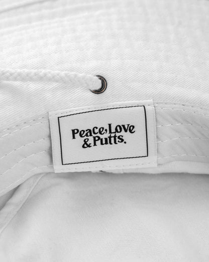 Detail of a white boonie hat with an interior woven label reading Peace, Love & Putts.