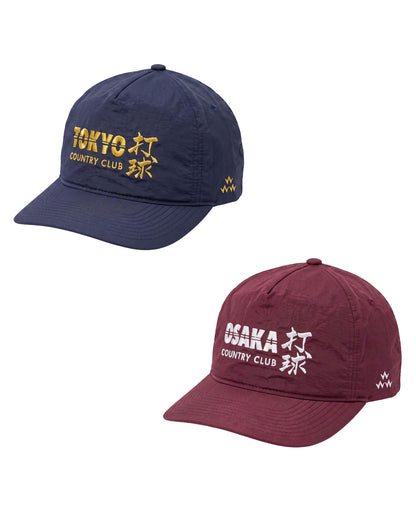 Two baseball caps shown on a plain white background: a navy cap with gold embroidered 'TOKYO COUNTRY CLUB' text and kanji, and a burgundy cap with white embroidered 'OSAKA COUNTRY CLUB' text and kanji.